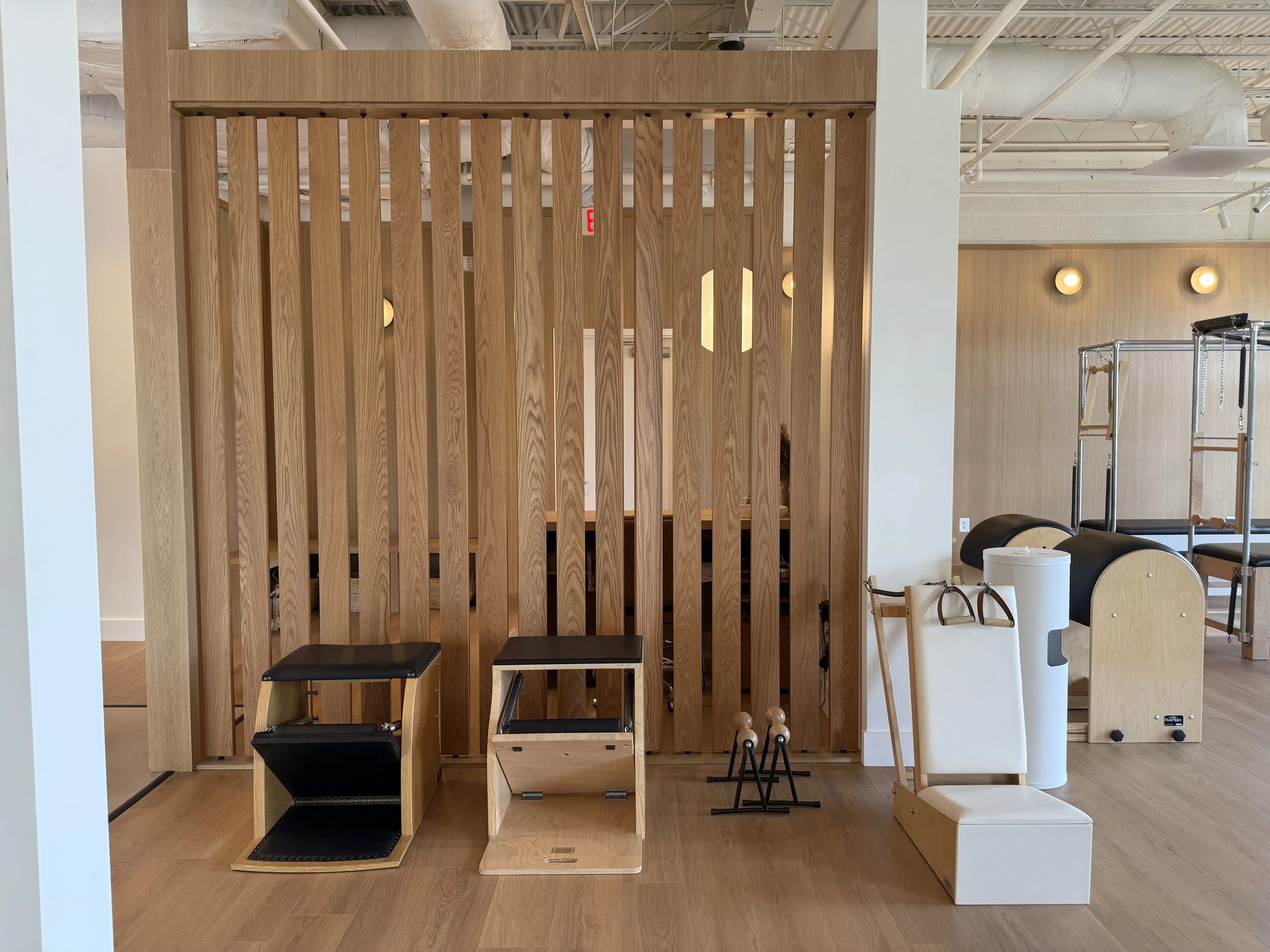 Warm wood and classical Pilates apparatus in the Great Falls studio