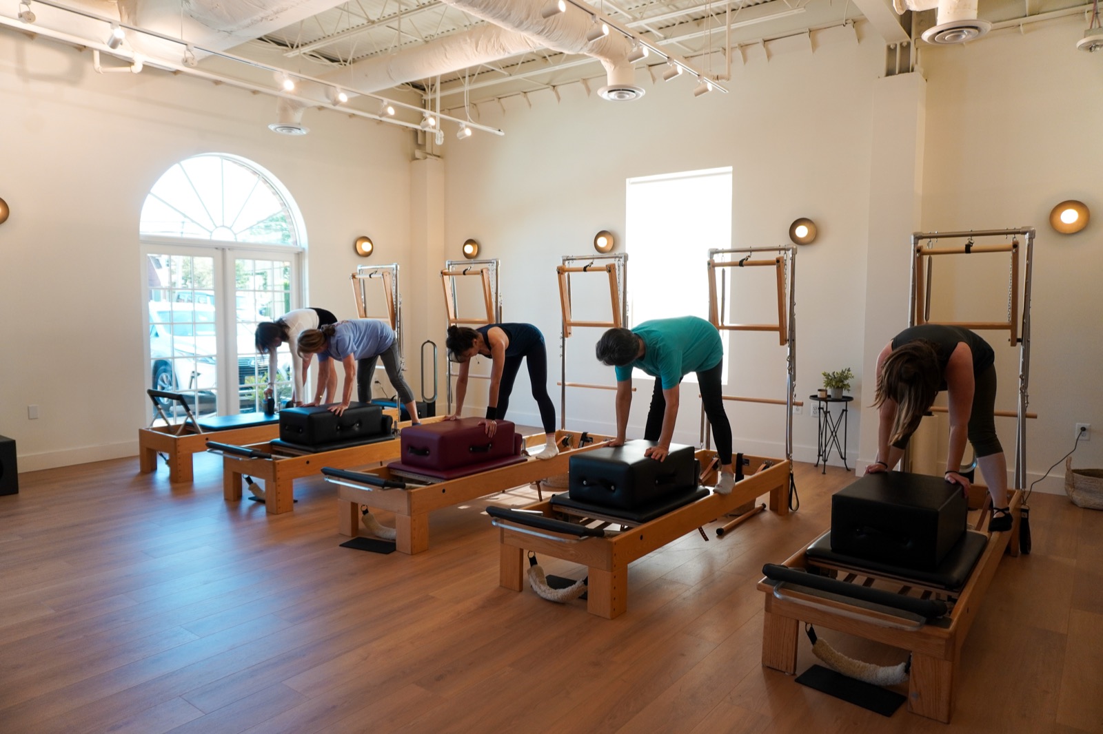 Participants practicing together on reformers at Great Falls Pilates