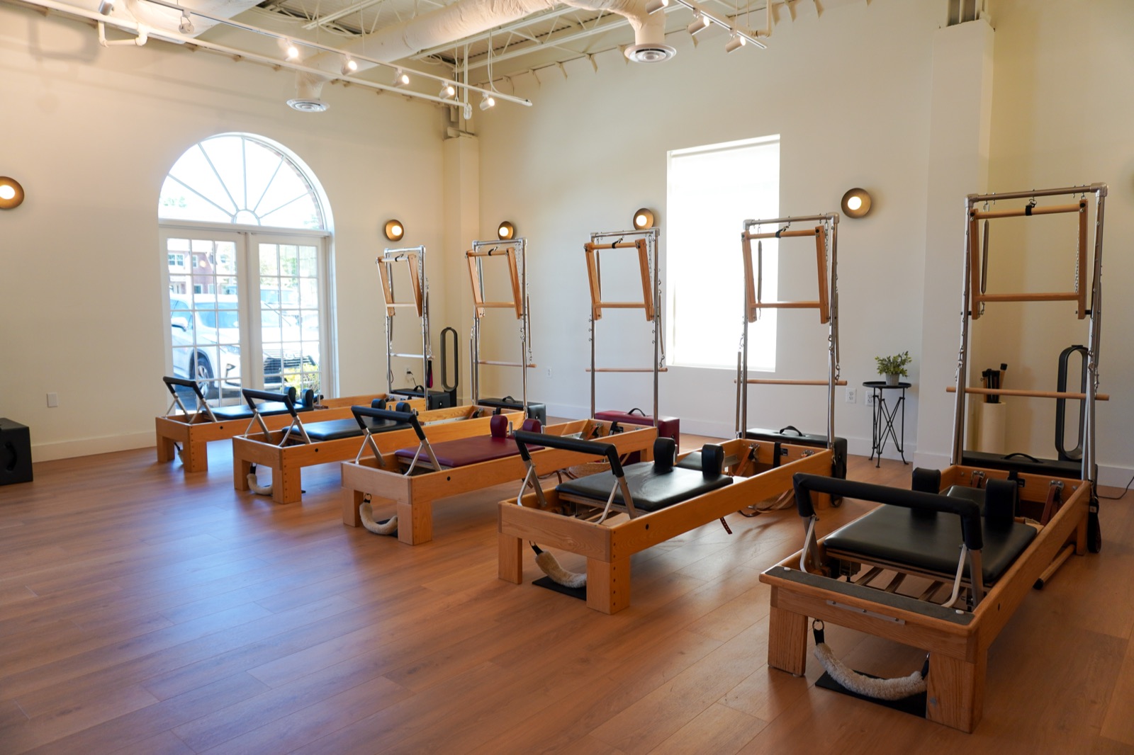 Sunlight through arched windows in the Great Falls Pilates studio